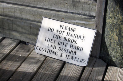 [ Sign next to parrots ]