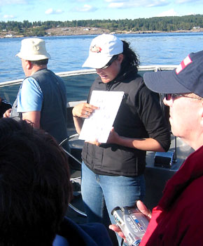 [ Our guide goes over the whale-spotting guide ]