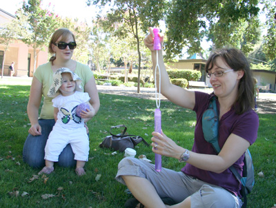[ Morgan scopes out Tyla's bubble wand ]
