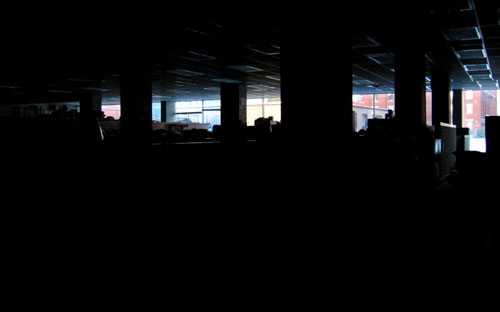 [ Darkened newsroom ]