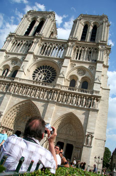 [ Guy taking a picture of Notre Dame ]