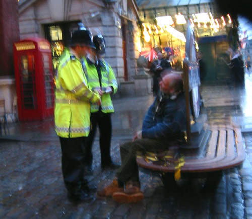 [ Cops rousting a homeless man ]